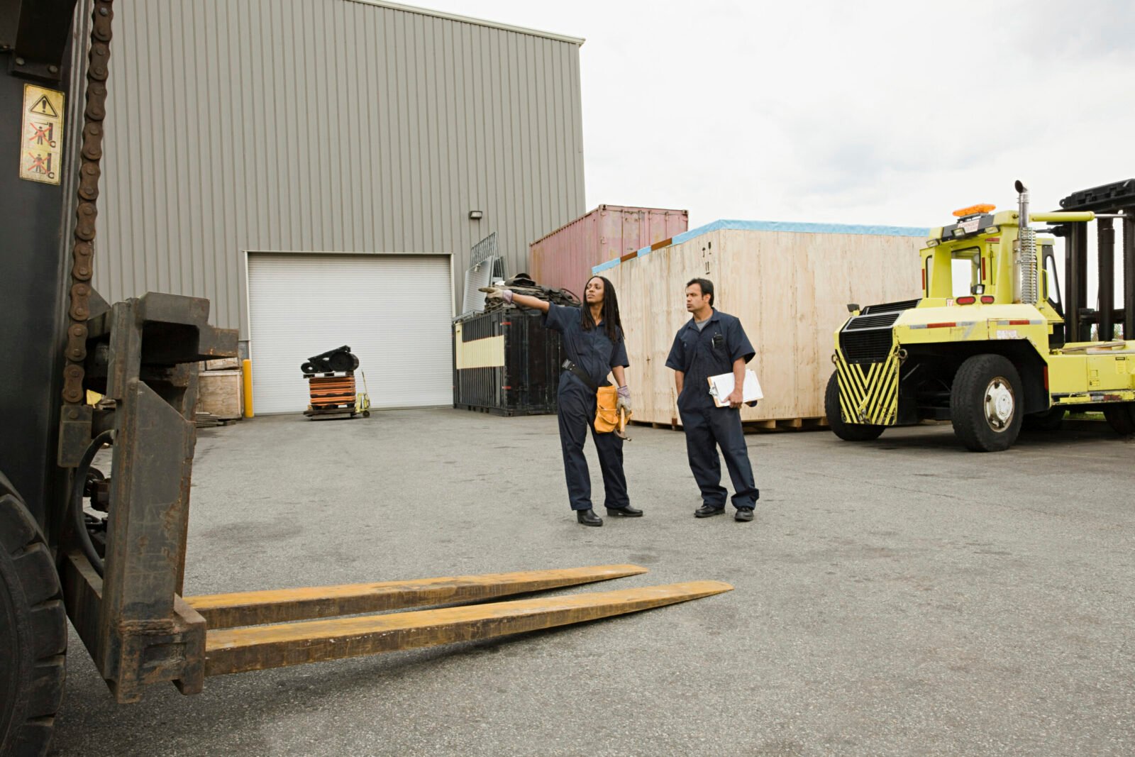 Two workers discussing logistics at a loading bay